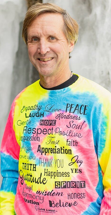 man wearing positive message neon tie dye shirt